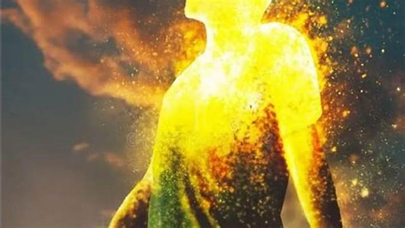May include: A digital illustration of a human silhouette composed of vibrant yellow and orange flames, with particles of light and embers dissipating into a dark, smoky atmosphere. The figure is shown from the chest up, facing upward.