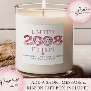May include: A white candle in a clear glass container with a lit wick. The candle has a label with the text "LIMITED EDITION 2008 Scarlett" and a message. The candle is a personalized gift.