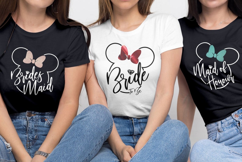 May include: Three black t-shirts with white text and a cartoon mouse head design. The shirts say "Brides Maid", "Bride To Be", and "Maid of Honour".
