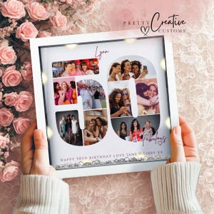 May include: A white square shadow box frame containing a photo collage arranged in the shape of the number 50. The text "Lynn" appears at the top, and "& Fabulous" and "HAPPY 50TH BIRTHDAY LOVE JANE & LIBBY XX" are printed at the bottom.