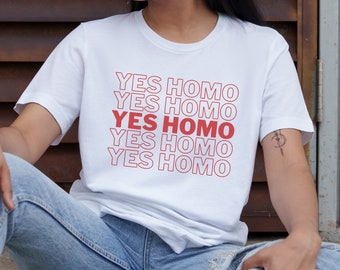 May include: White t-shirt with the phrase "YES HOMO" repeated five times in red.