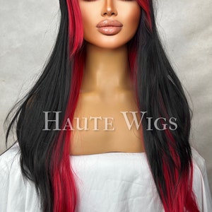 May include: A long black wig with red highlights and a side-swept fringe. The wig has the text "Haute Wigs" in the center. The wig is styled on a mannequin head against a neutral background.