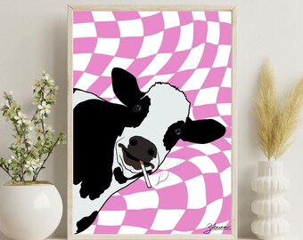 May include: Framed art print featuring a black and white cow with a cigarette, set against a pink and white checkered background. The cow is smiling. The artwork is in a wooden frame.