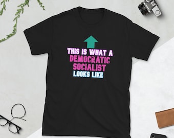 May include: Black t-shirt with a white arrow pointing upwards and the text "This is what a Democratic Socialist looks like" in pink and blue.