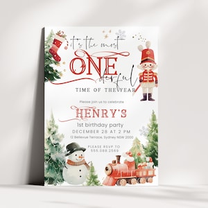 May include: A white birthday invitation card featuring watercolor illustrations of a nutcracker, a snowman, a red train, and a Christmas stocking. The text reads: It's the most ONE-derful TIME OF THE YEAR, HENRY'S 1st birthday party, DECEMBER 28 AT 2 PM.