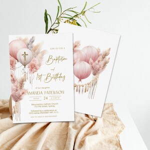 May include: A pink and gold baptism and first birthday invitation with a watercolor illustration of balloons, pampas grass, and a cross. The text reads "Join us for a Baptism and 1st Birthday of our daughter Amanda Paterson August 24 at 3:00 PM Resurrection Catholic Church 157 Pitt Street, Sydney Followed by a celebration at 1073 Sidney ERZS&Eacute;BET KRT. 9-11. RSVP to (XXX) XXX-XXXX"