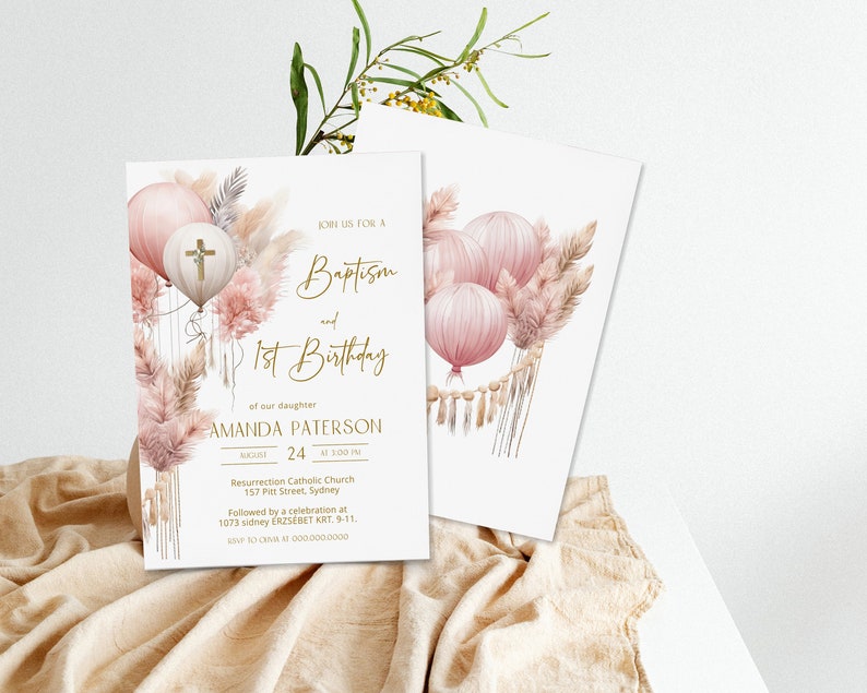 May include: A pink and gold baptism and first birthday invitation with a watercolor illustration of balloons, pampas grass, and a cross. The text reads "Join us for a Baptism and 1st Birthday of our daughter Amanda Paterson August 24 at 3:00 PM Resurrection Catholic Church 157 Pitt Street, Sydney Followed by a celebration at 1073 Sidney ERZS&Eacute;BET KRT. 9-11. RSVP to (XXX) XXX-XXXX"