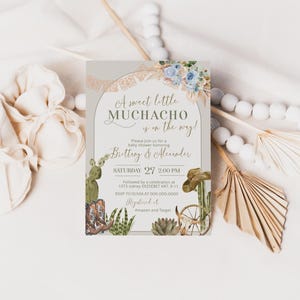 May include: A light gray baby shower invitation with a gold archway and a floral design. The text reads "A sweet little MUCHACHO is on the way!"  Please join us for a baby shower honoring Brittany & Alexander. Saturday 27 2:00 PM. Followed by a celebration at 1073 sidney ERZSÉBET KRT. 9-11. RSVP to OUVIA at 000.000.0000. Registered at Amazon and Target.