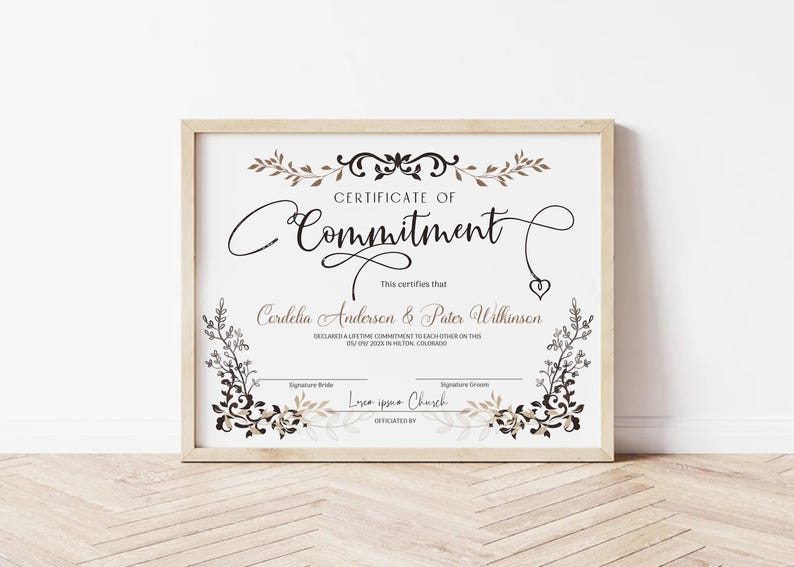 May include: A framed certificate with the words "Certificate of Commitment" in elegant script. The certificate includes names, a declaration, and space for signatures. Decorative floral elements in brown and black adorn the edges.