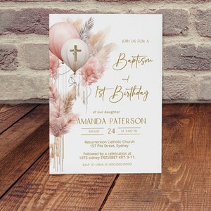May include: A white invitation card with a gold border and text. The card features a watercolor illustration of pink and white balloons with a cross on one of the balloons. The text reads "Join us for a Baptism and 1st Birthday of our daughter Amanda Paterson August 24 at 3:00 PM Resurrection Catholic Church 157 Pitt Street, Sydney Followed by a celebration at 1073 sidney &Eacute;RZS&Eacute;BET KRT. 9-11. RSVP to OUVIA at 000.000.0000"