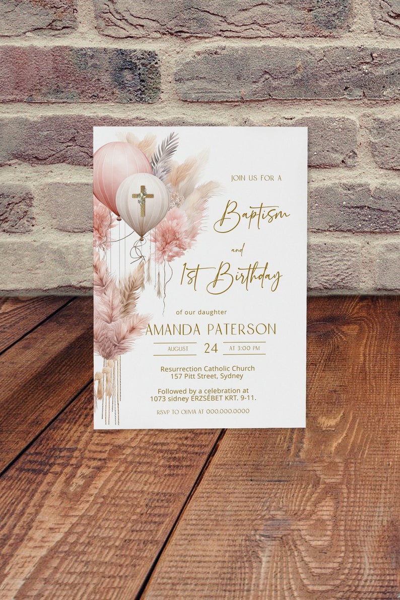 May include: A white invitation card with a gold border and text. The card features a watercolor illustration of pink and white balloons with a cross on one of the balloons. The text reads "Join us for a Baptism and 1st Birthday of our daughter Amanda Paterson August 24 at 3:00 PM Resurrection Catholic Church 157 Pitt Street, Sydney Followed by a celebration at 1073 sidney &Eacute;RZS&Eacute;BET KRT. 9-11. RSVP to OUVIA at 000.000.0000"