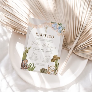 May include: A light beige invitation card with a gold border and text. The card features a watercolor illustration of a cross, cacti, and cowboy boots. The text reads "Bautizo" and "Pedro Rodriguez" with the date "Sabado 27 Agosto". The card also includes details for a Mass and a celebration.
