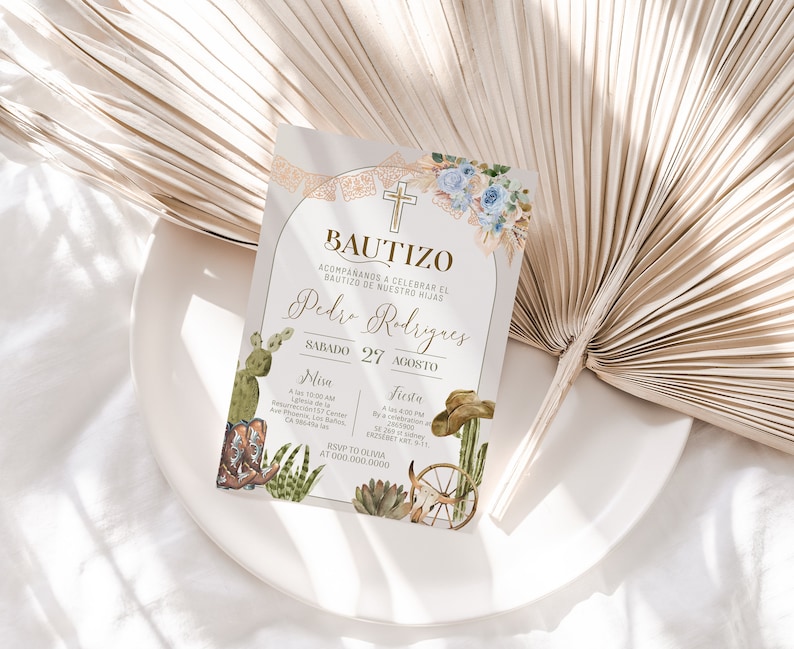 May include: A light beige invitation card with a gold border and text. The card features a watercolor illustration of a cross, cacti, and cowboy boots. The text reads "Bautizo" and "Pedro Rodriguez" with the date "Sabado 27 Agosto". The card also includes details for a Mass and a celebration.