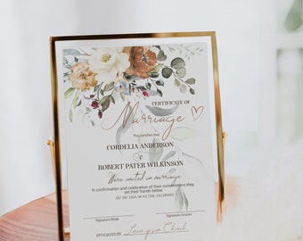 May include: A marriage certificate featuring a floral design in shades of white, brown, and green. The text reads "Certificate of Marriage" with a heart symbol. The names "Cordelia Anderson" and "Robert Pater Wilkinson" are listed below. The date "05/09/2024" and location "Hilton, Colorado" are also included. The text "Officiated by Lorem ipsum Church" is at the bottom.