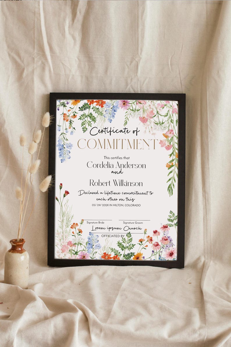 May include: A framed certificate with the words "Certificate of Commitment" and floral accents. The certificate includes the names Cordelia Anderson and Robert Wilkinson, and the date 05/09/202X in Hilton, Colorado.