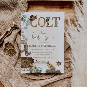 May include: A white baptism invitation with a western theme. The invitation features a cowboy hat, boots, cacti, and a wagon wheel. The text on the invitation reads "COLT baptism of our son ROBERT PATERSON SATURDAY, AUGUST 7, 20XX AT 2 PM Resurrection Catholic Church 157 Pitt Street, Sydney 1073 sidney ERZS&Eacute;BET KRT. 9-11. RSVP TO OLIVIA AT 000.000.0000."