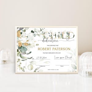May include: A framed certificate with the words "CHILD dedication" in elegant script. The certificate features floral and gold leaf accents, with text fields for the child's name, date, and church details. The certificate is for Robert Paterson.