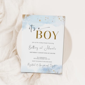 May include: A blue and gold baby shower invitation with the text "it's a BOY" in gold lettering. The invitation includes the names Brittany and Alexander, the date and time of the shower, and the location. It also includes the text "Registered at Amazon and Target".