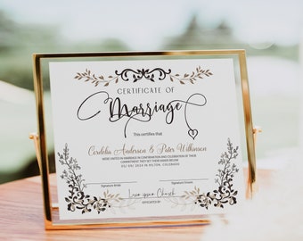 May include: A white certificate of marriage with a gold frame. The certificate features a decorative floral design and the text "Certificate of Marriage" in a cursive font. The text "This certifies that" is followed by the names "Cordelia Andersen & Pater Wilkinson" and the date "05/09/2024". The text "OFFICIATED BY" is followed by the name "Lorem ipsum Church".