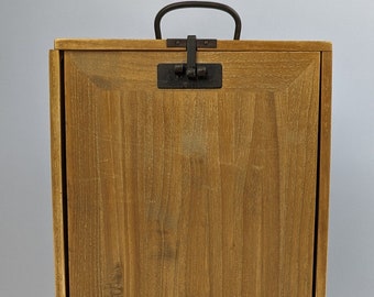 May include: A wooden box with a hinged lid and a metal handle. The box is closed and has a natural wood finish.