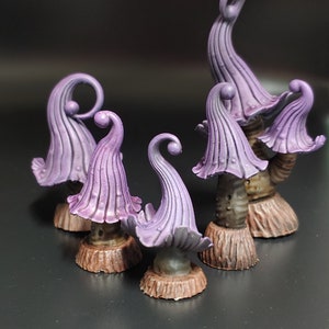 May include: Five purple and brown mushroom-shaped figurines with intricate details. The mushrooms are painted in a gradient of purple shades and have a textured surface. The bases of the mushrooms are brown and resemble tree trunks.