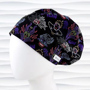 May include: Black surgical scrub cap with a neon-style design featuring various cartoon villains. The cap has a repeating pattern of villain faces and the word "Villains" in white and neon colors. The cap is on a white mannequin head.