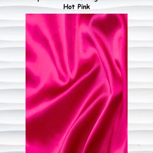 May include: A close-up of hot pink satin fabric with visible folds and a glossy sheen. The text "Optional Satin Lining will be Hot Pink" is displayed at the top of the image.