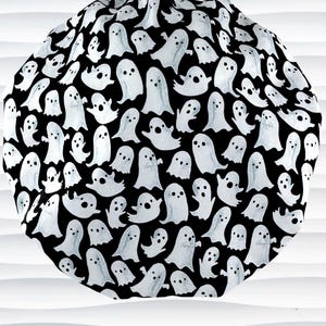 Bouffant style surgical scrub cap with white animated ghosts all over this black cotton fabric.
