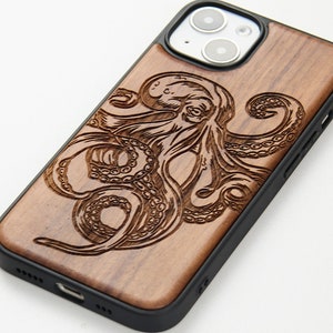 May include: A wooden phone case with a black border and a carved octopus design. The case is made of natural wood and has a rustic look.