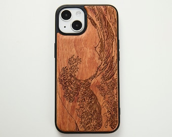 May include: A wooden iPhone case with a laser-engraved design of the Great Wave off Kanagawa. The case is brown with a black border.