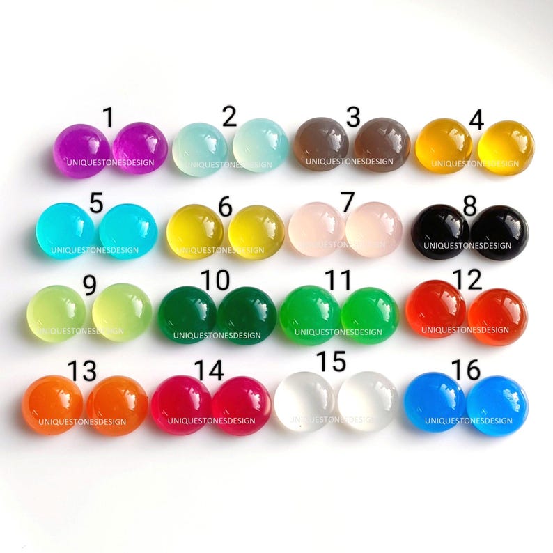 May include: A collection of 16 round cabochon gemstones in various colors, including purple, blue, green, yellow, orange, red, pink, white, black, and gray. Each gemstone is labeled with a number from 1 to 16.