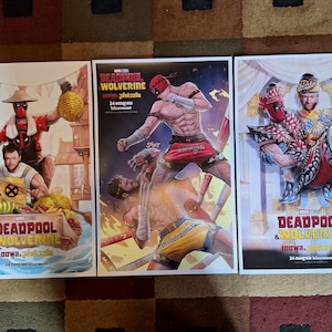 May include: Three movie posters for the film "Deadpool & Wolverine: Loo Wa." The posters feature different scenes from the film, including a fight scene, a scene with Deadpool and Wolverine in traditional Thai clothing, and a scene with Deadpool and Wolverine in a jungle setting. The posters are all in the same style, with a red and black color scheme and a bold font.
