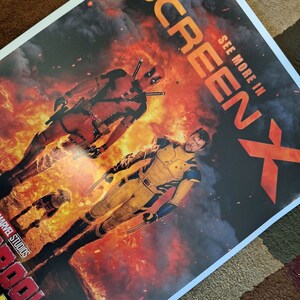 May include: A movie poster for the film "Deadpool 2" featuring Deadpool and Wolverine in a fiery scene. The poster includes the text "See More In ScreenX" and "Marvel Studios".