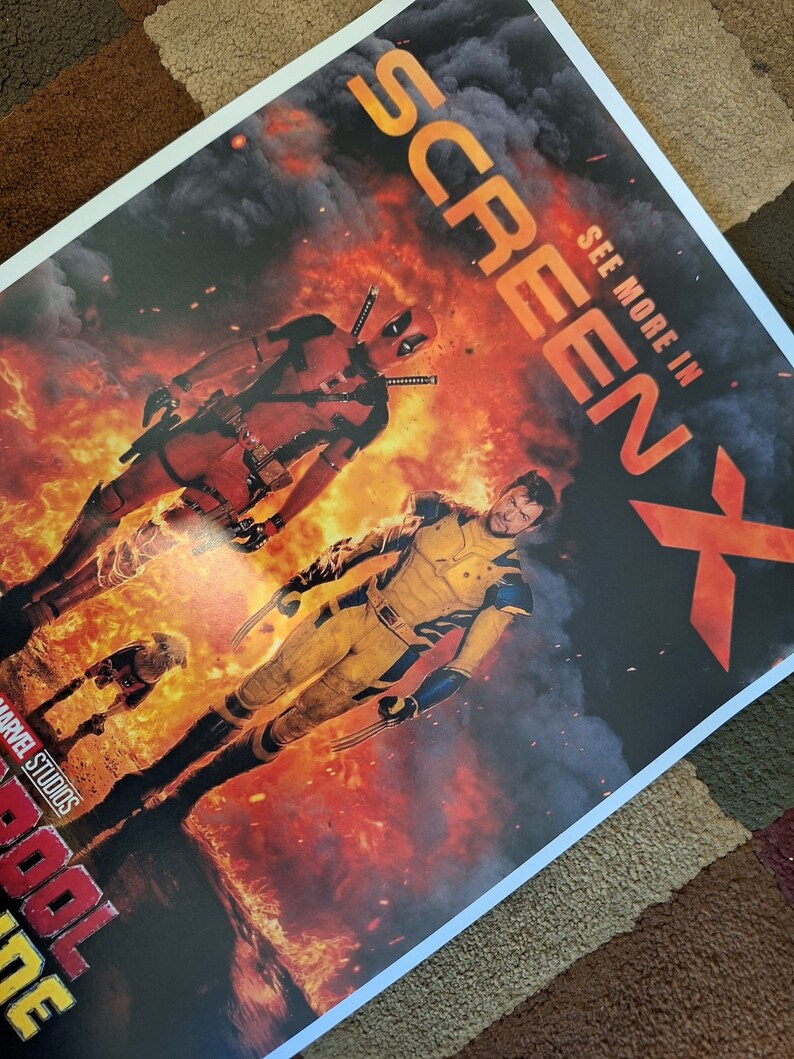 May include: A movie poster for the film "Deadpool 2" featuring Deadpool and Wolverine in a fiery scene. The poster includes the text "See More In ScreenX" and "Marvel Studios".