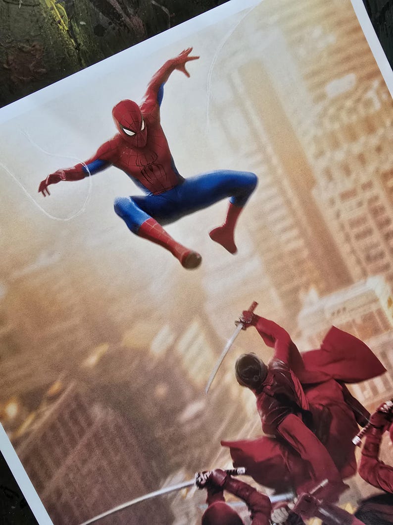 K&ouml;nnte beinhalten: Ein Druck, der Spider-Man in einem roten und blauen Anzug in einer dynamischen Pose zeigt, der ein Netz schie&szlig;t. Darunter k&auml;mpfen Figuren in roten Outfits mit Schwertern vor einem verschwommenen Stadtbild.