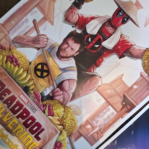 May include: A colorful illustration of Deadpool and Wolverine in a boat filled with fruit. Deadpool is wearing a red and white suit with a traditional Asian hat and a white towel around his neck. Wolverine is wearing a yellow and blue shirt with the X-Men logo. The text "Deadpool Wolverine" is written in red and white letters on the side of the boat.