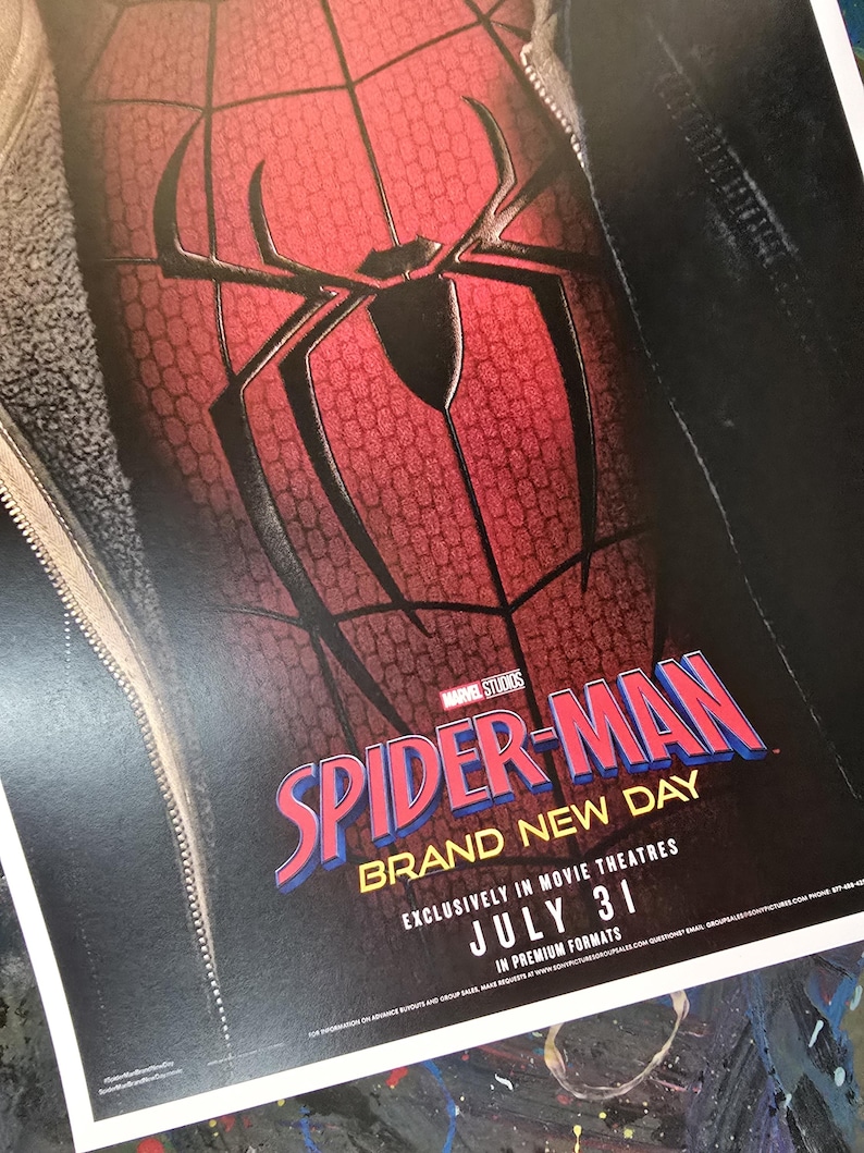 May include: A movie poster featuring a red and black textured Spider-Man suit with a large black spider emblem on the chest. The text reads Marvel Studios Spider-Man Brand New Day, Exclusively in Movie Theatres, July 31, in premium formats.