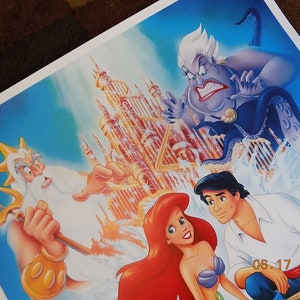 May include: A colorful illustration of characters from the Disney movie The Little Mermaid. Ariel, the mermaid princess, is in the foreground with Prince Eric. King Triton, Ariel's father, is in the background with his trident. Ursula, the sea witch, is in the upper left corner. The background features a golden castle.