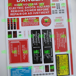 May include: A set of red and black warning stickers with the text "DANGER HIGH VOLTAGE 1KV ELECTRIC SHOCK HAZARD REMOVE POWER BEFORE REPAIR OR ADJUSTMENT". The stickers are for industrial use and feature various safety warnings and instructions.