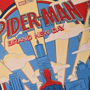 May include: A graphic poster featuring Spider-Man standing in front of a city skyline. The text reads Marvel Studios Spider-Man Brand New Day. The art style uses bold red, blue, and cream colours with stylised buildings and clouds in the background.