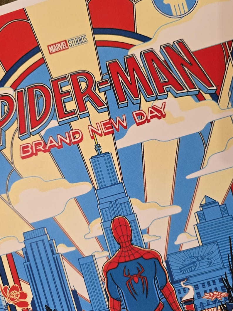 May include: A graphic poster featuring Spider-Man standing in front of a city skyline. The text reads Marvel Studios Spider-Man Brand New Day. The art style uses bold red, blue, and cream colours with stylised buildings and clouds in the background.