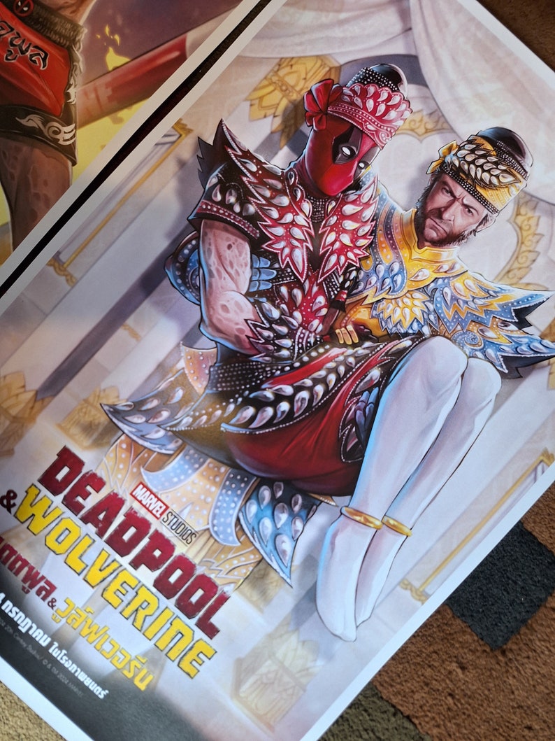 May include: A poster featuring Deadpool and Wolverine in traditional Thai clothing. The poster is titled "Deadpool & Wolverine" with the text "MARVEL STUDIOS" above the title. The text below the title is in Thai.