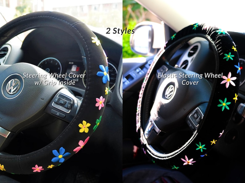 May include: Two black steering wheel covers with floral embroidery. One cover has the text "Steering Wheel Cover w/ Grip Inside". The other cover has the text "Elastic Steering Wheel Cover". The flowers are in various colours.