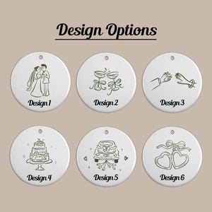 May include: Six white circular ornaments with dark green line art designs labeled Design 1 through Design 6. The illustrations feature a wedding couple, champagne glasses, a ring exchange, a tiered cake, a getaway car, and two linked hearts.