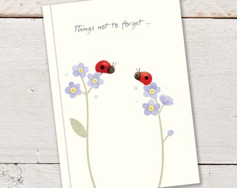 A6 96pp Notebook featuring two cute ladybirds sitting on top of forget-me-not flowers on a pale cream background colour. Notebook is ruled.