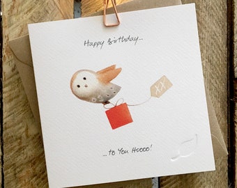 Birthday Card featuring Flying Barn Owl carrying a present, beautifully Illustrated. Caption reads 'Happy birthday to You Hooo!