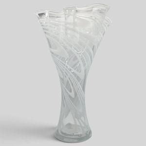 May include: A clear glass vase featuring a flared, wavy rim and a narrow base. The body of the vase is decorated with swirling, opaque white glass patterns that create a dynamic, fluid design throughout the transparent structure of the vessel.