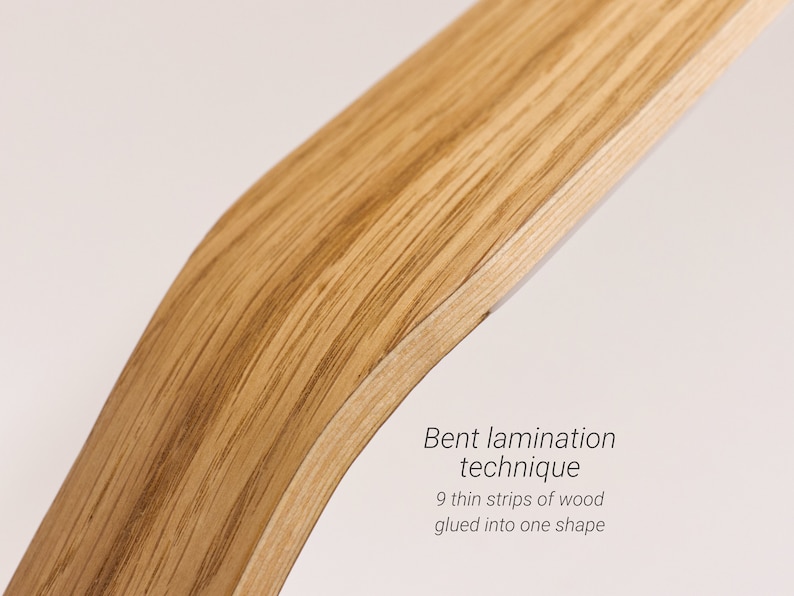 May include: Close-up of a curved piece of wood, showing the grain and texture. The text "Bent lamination technique 9 thin strips of wood glued into one shape" is visible below the wood.