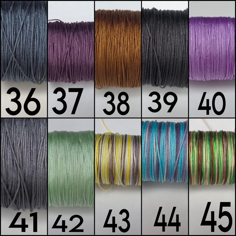 May include: A grid of ten spools of thread labeled 36 through 45. The colors include dark gray, deep purple, copper, black, light purple, medium gray, sage green, yellow and white stripes, blue and purple stripes, and green and brown stripes.