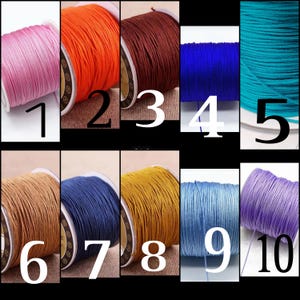 May include: Ten spools of waxed cotton cord in various colors, including pink, orange, brown, blue, turquoise, beige, navy, gold, light blue, and lavender. The spools are numbered 1 through 10.
